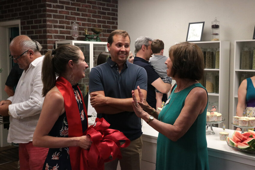 Bridget Molloy and her husband chat with At-Large Councilmember Pam Grove at the grand opening.